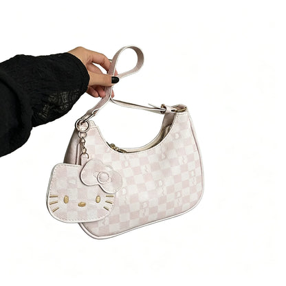 Cute Hello Kitty handbag with checkerboard pattern and cartoon pendant