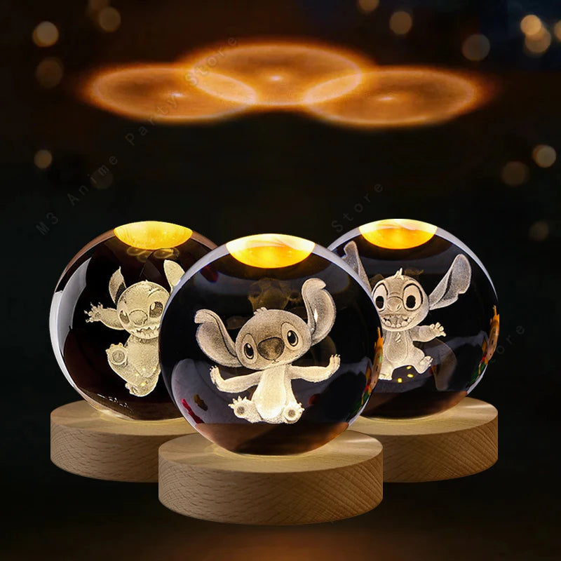 Three crystal balls with engraved cartoon characters on wooden bases against a dark background.